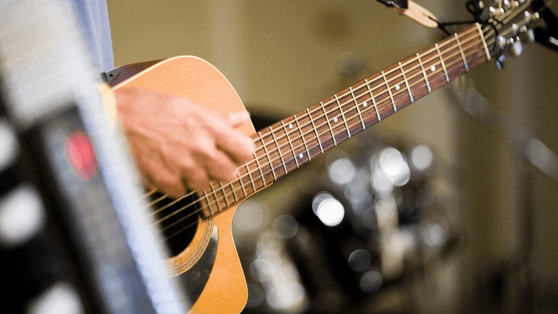 performer playing guitar at summer sessions concert series in Stony Plain