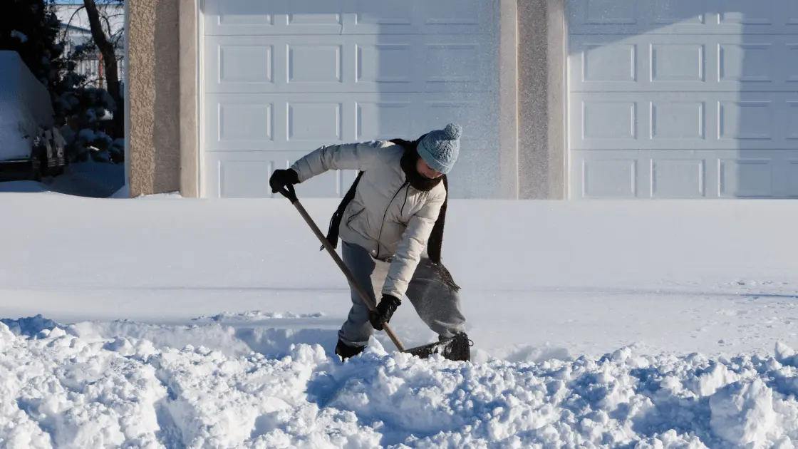 clearing snow during Alberta winter